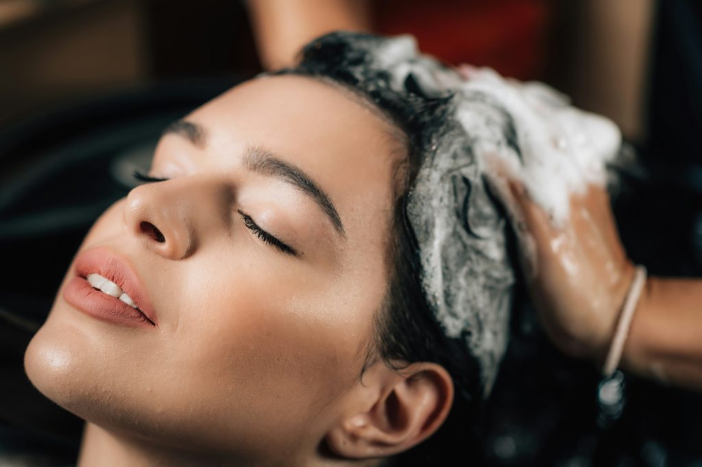 Hairstylist Applying Shampoo on Woman’s Hair